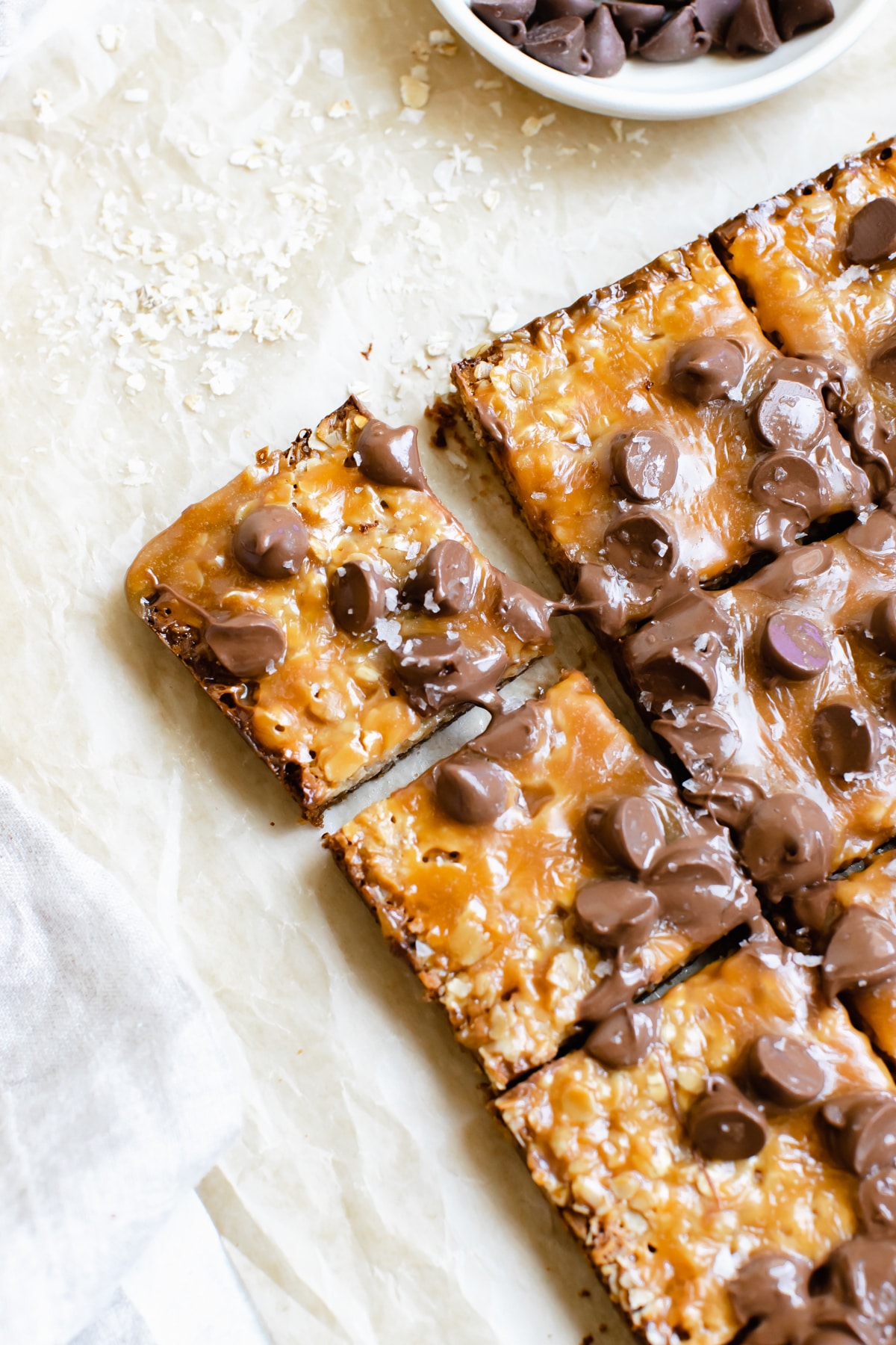 freshly baked caramel bars topped with chocolate chips and flaky sea salt