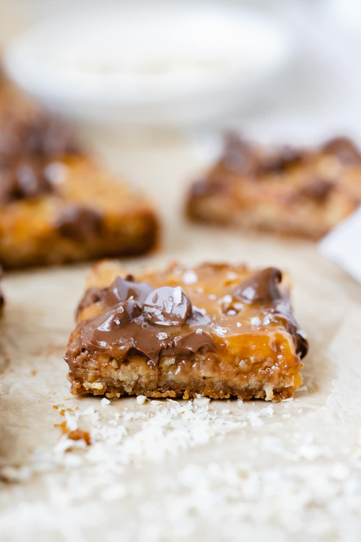 freshly baked caramel bar topped with chocolate chips and flaky sea salt
