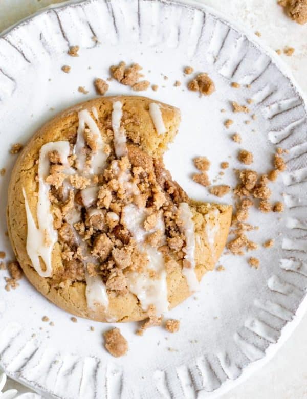 cookies on a white plate with powdered sugar icing on top