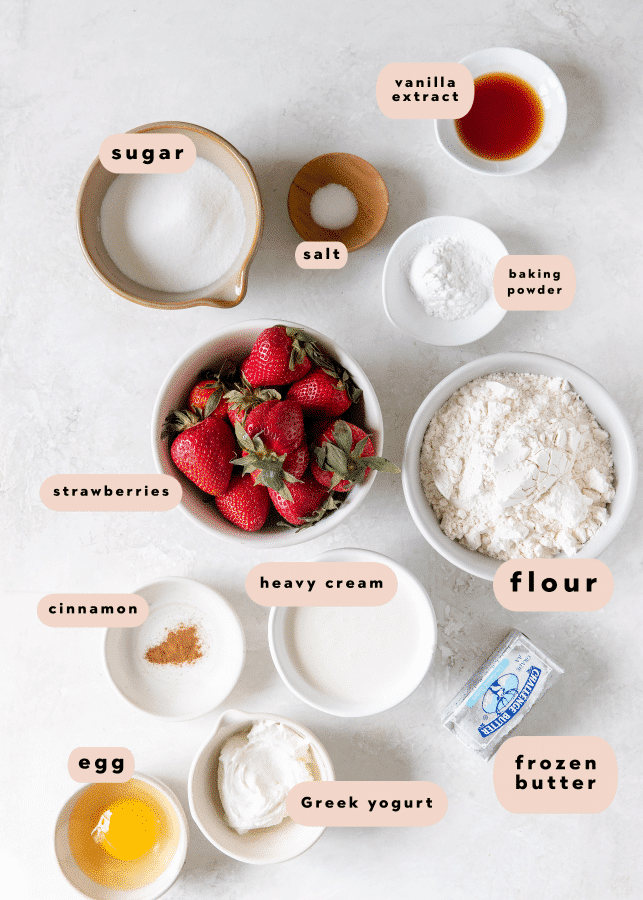 ingredients in small white bowls to make strawberry scones