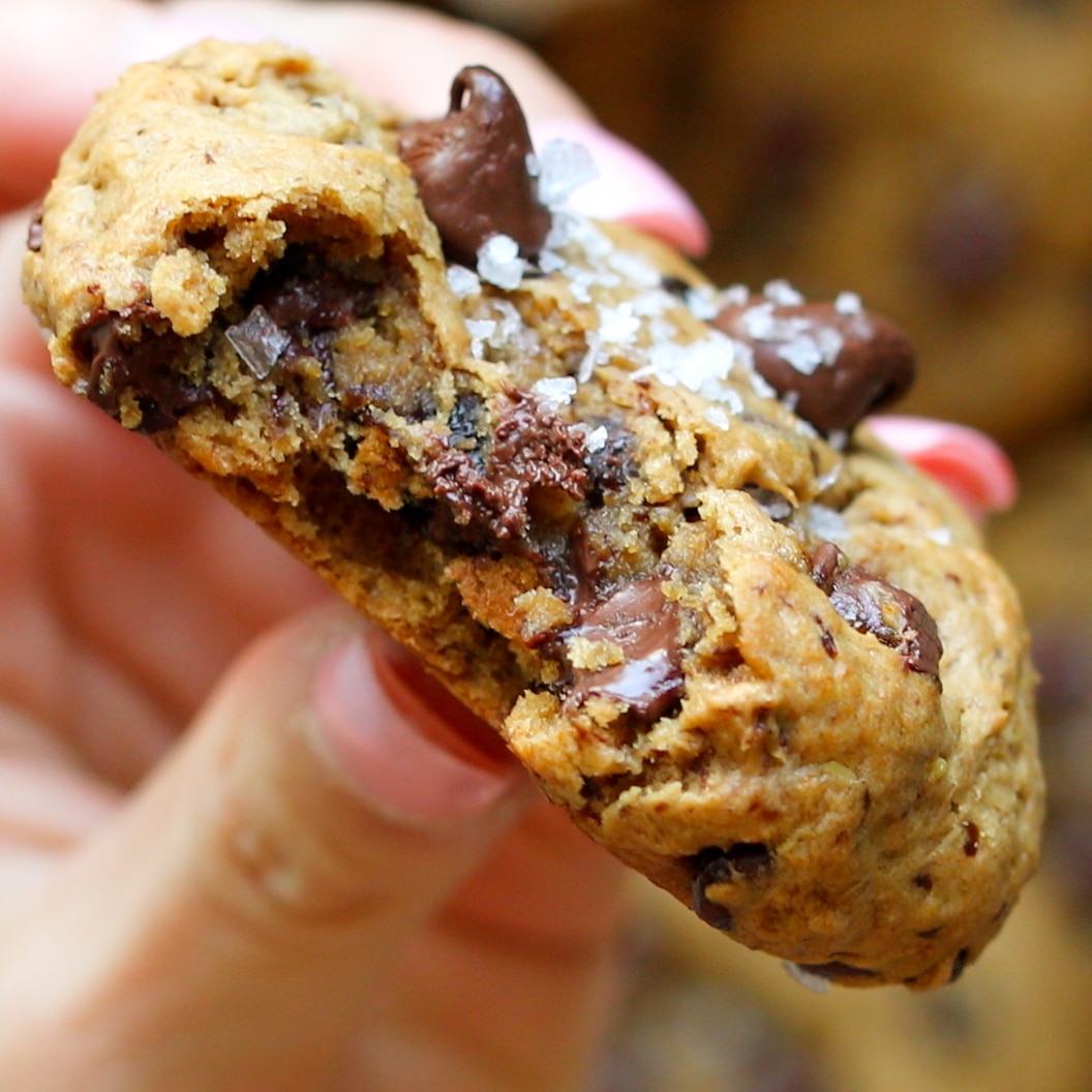 a woman's hand holding a cookie.