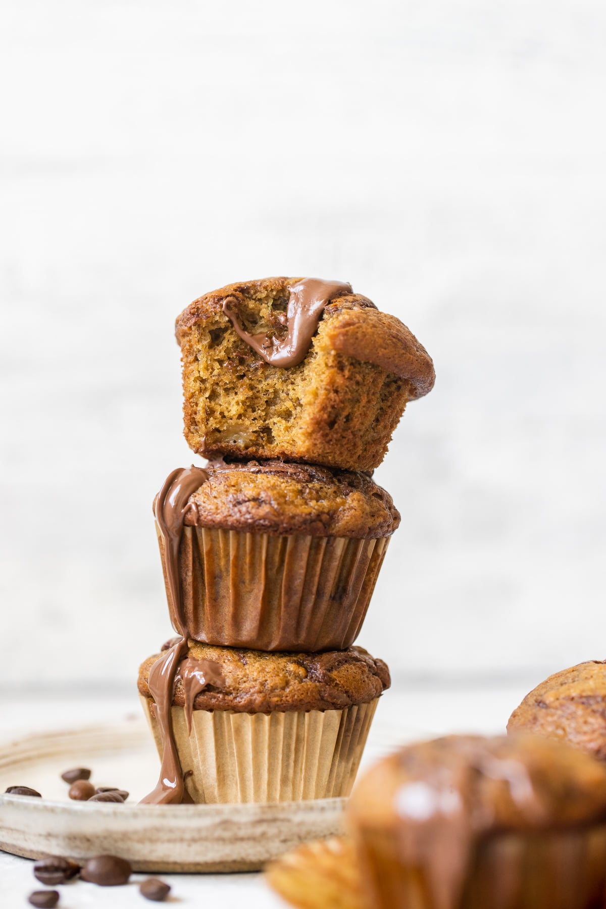 muffins stacked on each other with Nutella drizzled down the sides