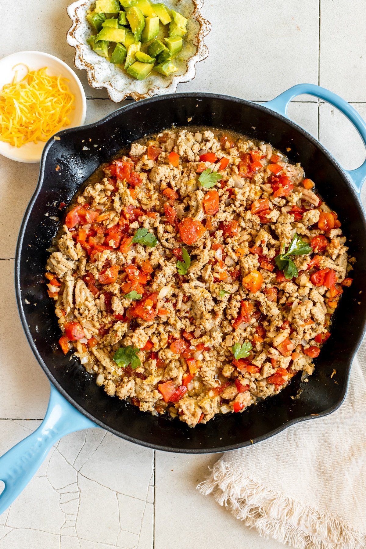 ground turkey in a cast iron pan garnished with parsley