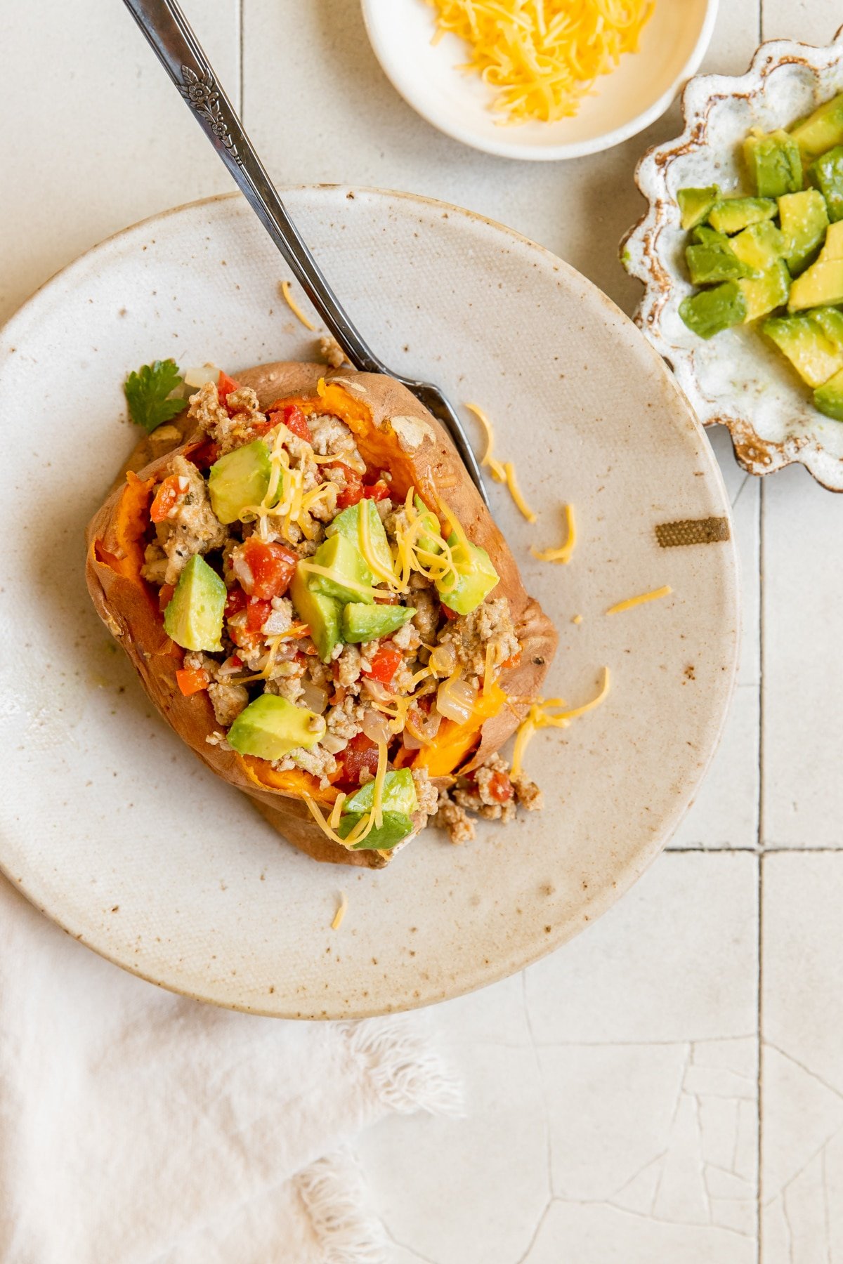 a sweet potato stuffed with ground turkey, avocado and cheese