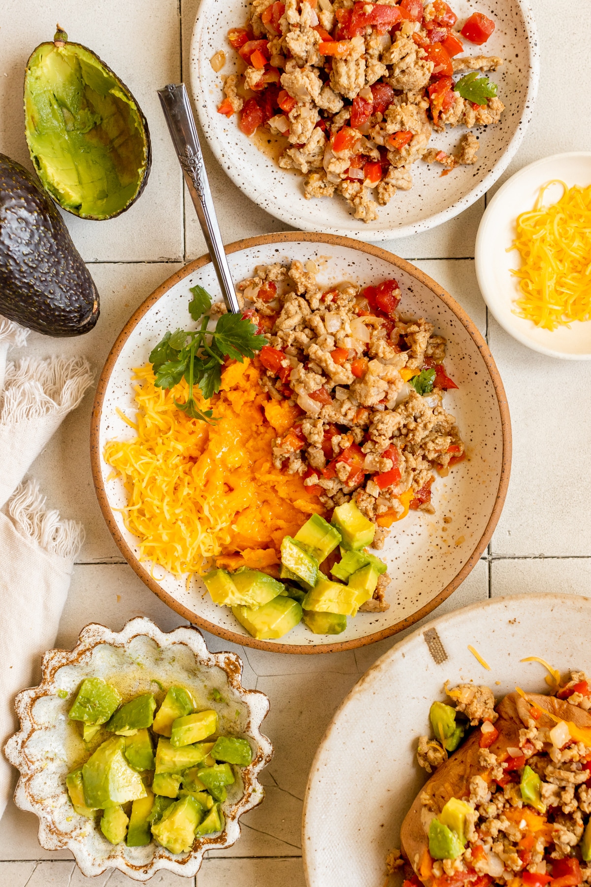 a ground turkey dinner bowl filled with sweet potato, ground turkey and avocado