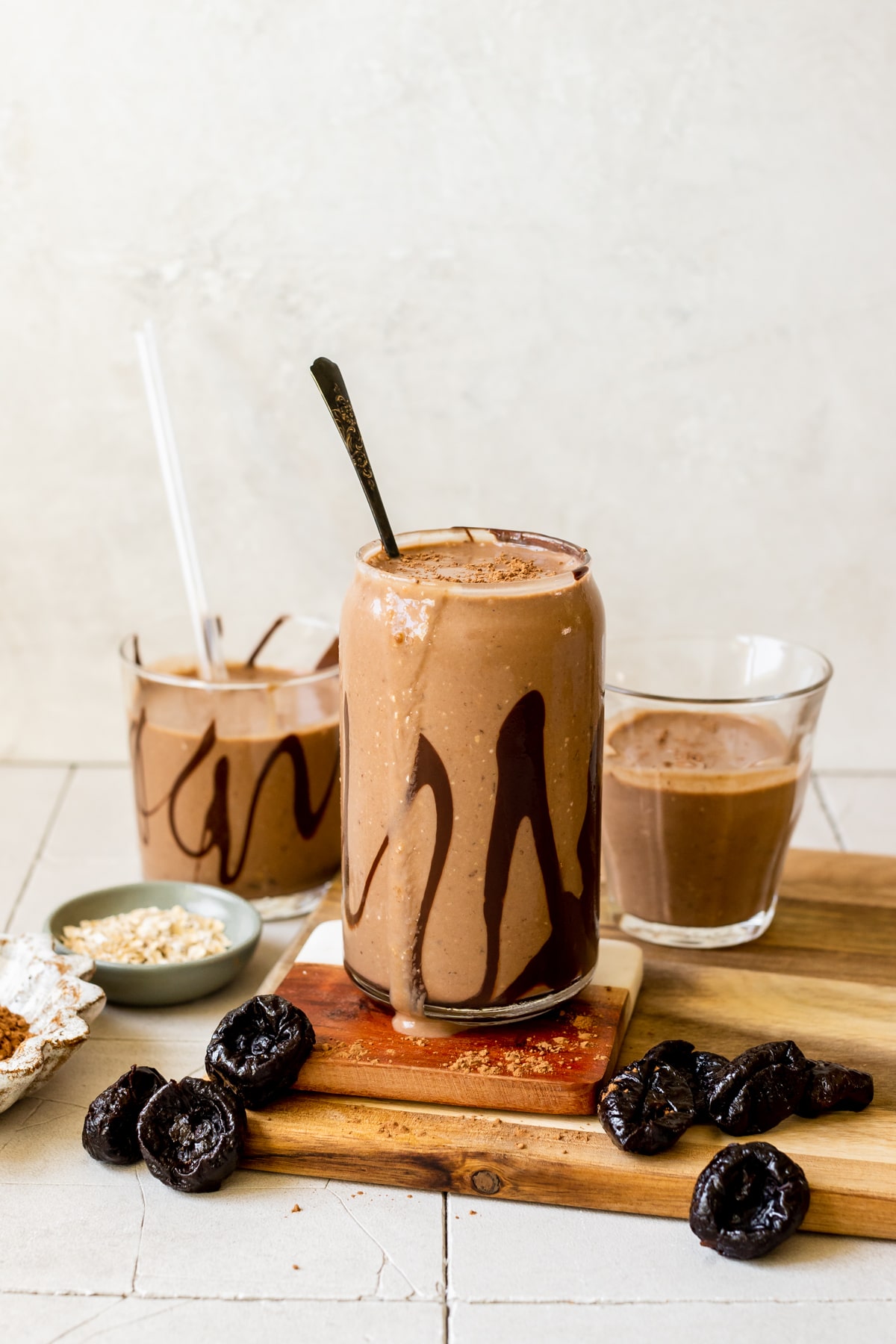 smoothies in glasses garnished with melted chocolate inside the glass