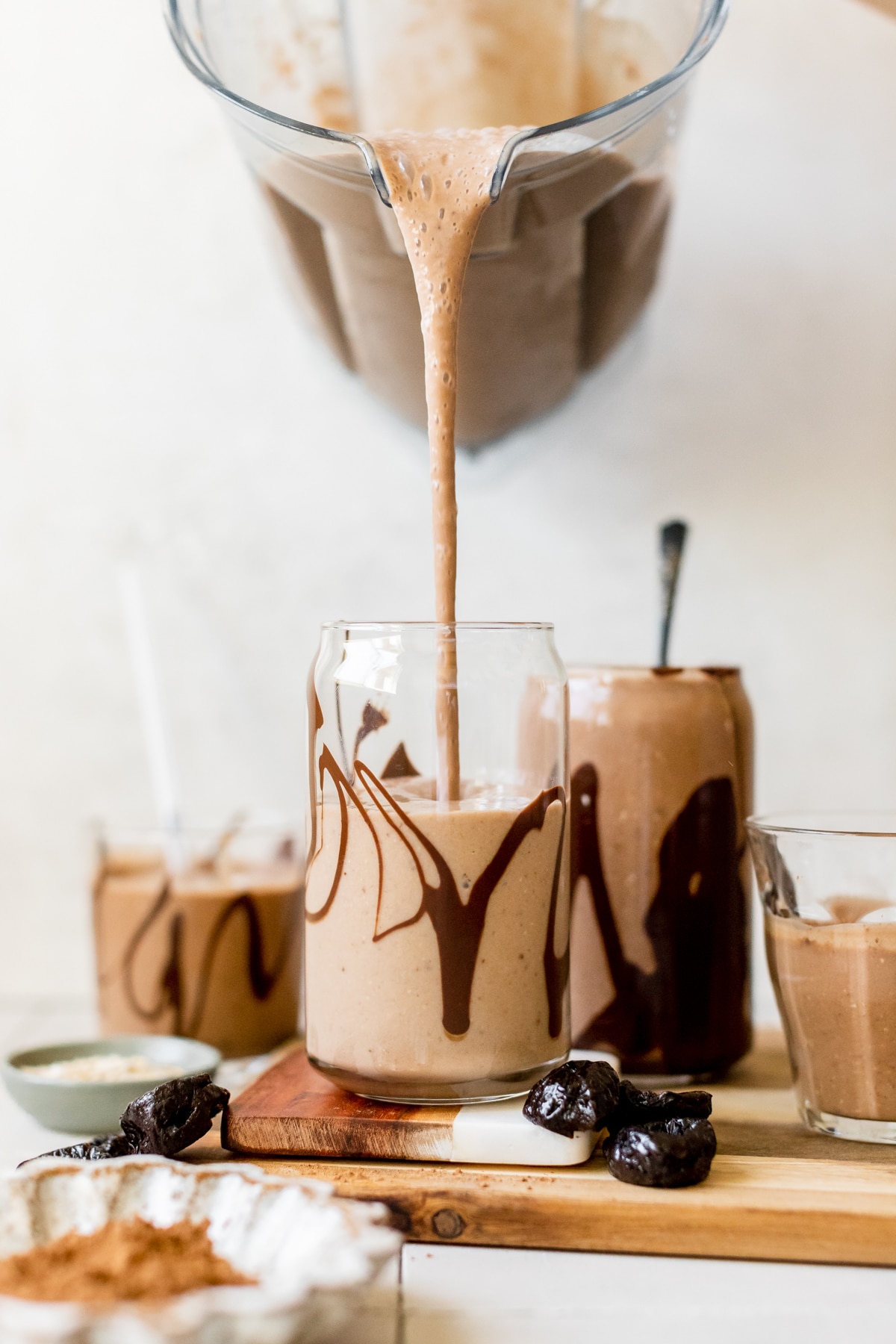 a smoothie being poured into a glass