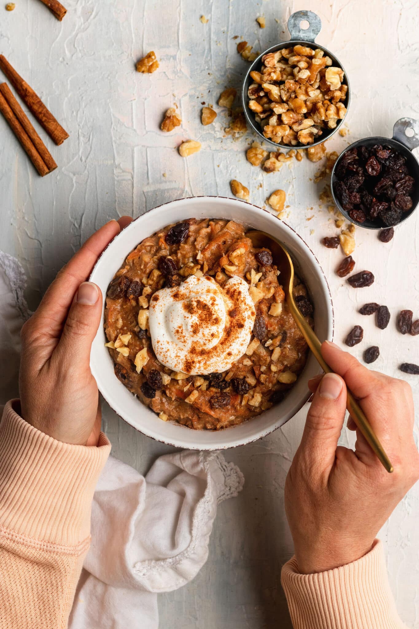 carrot cake oatmeal in a bowl topped with Greek yogurt and cinnamon