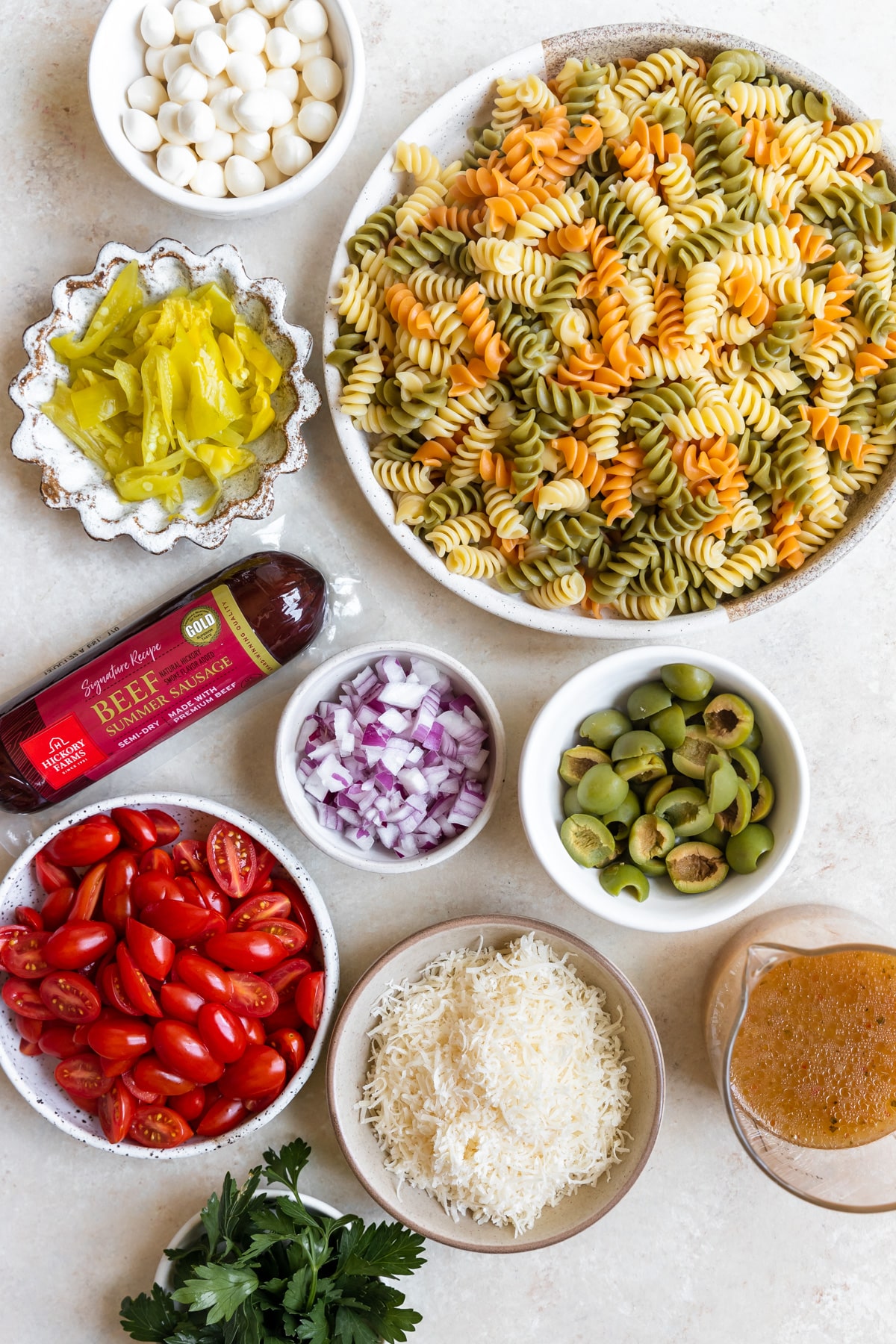 ingredients to make pasta salad in small bowls 