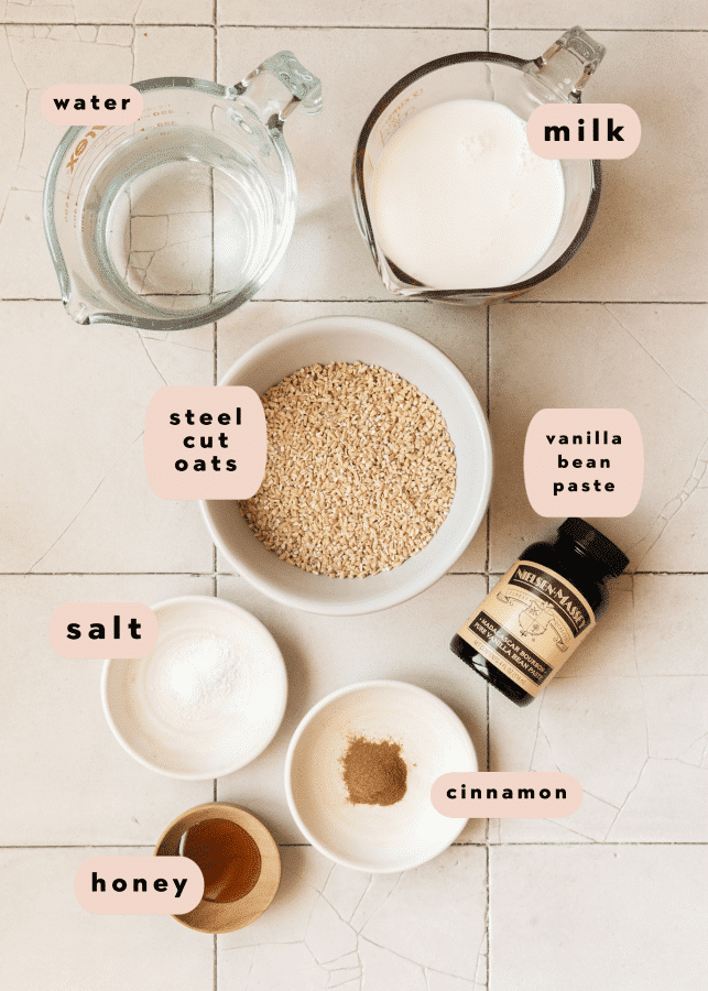 ingredients needed to make steel cut oats in bowls and measuring cups. 