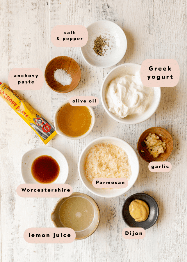 ingredients to make a homemade salad dressing in small glass dishes. 