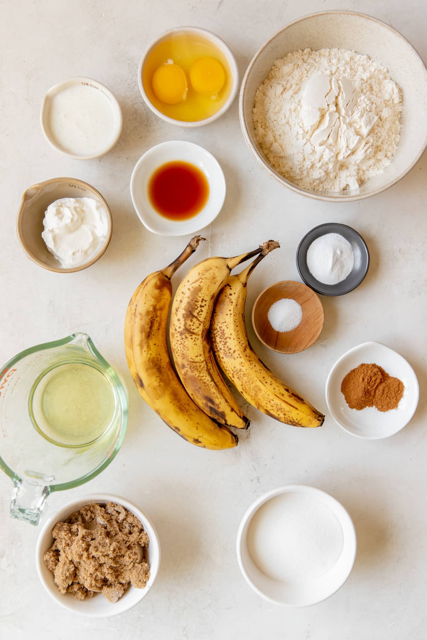 ingredients needed to make homemade banana bread in small bowls. 