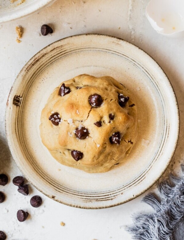 a cookie on a plate topped with flaky sea salt.