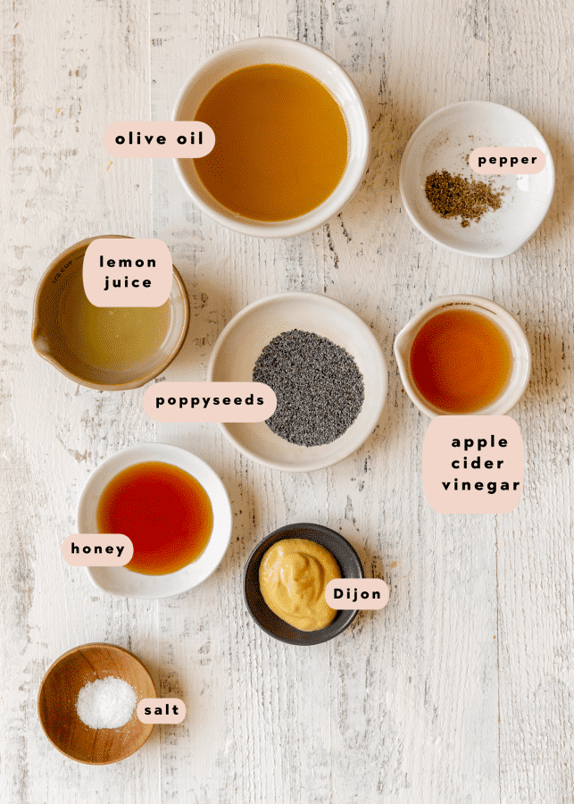 ingredients to make a homemade salad dressing in small glass dishes. 