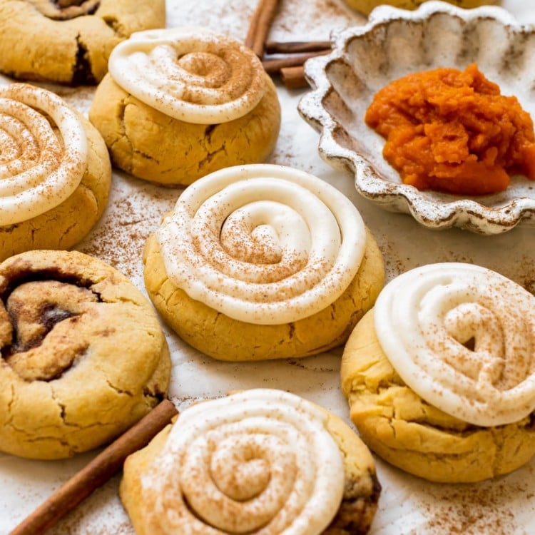 pumpkin cookies topped with cream cheese frosting and pumpkin pie spice.