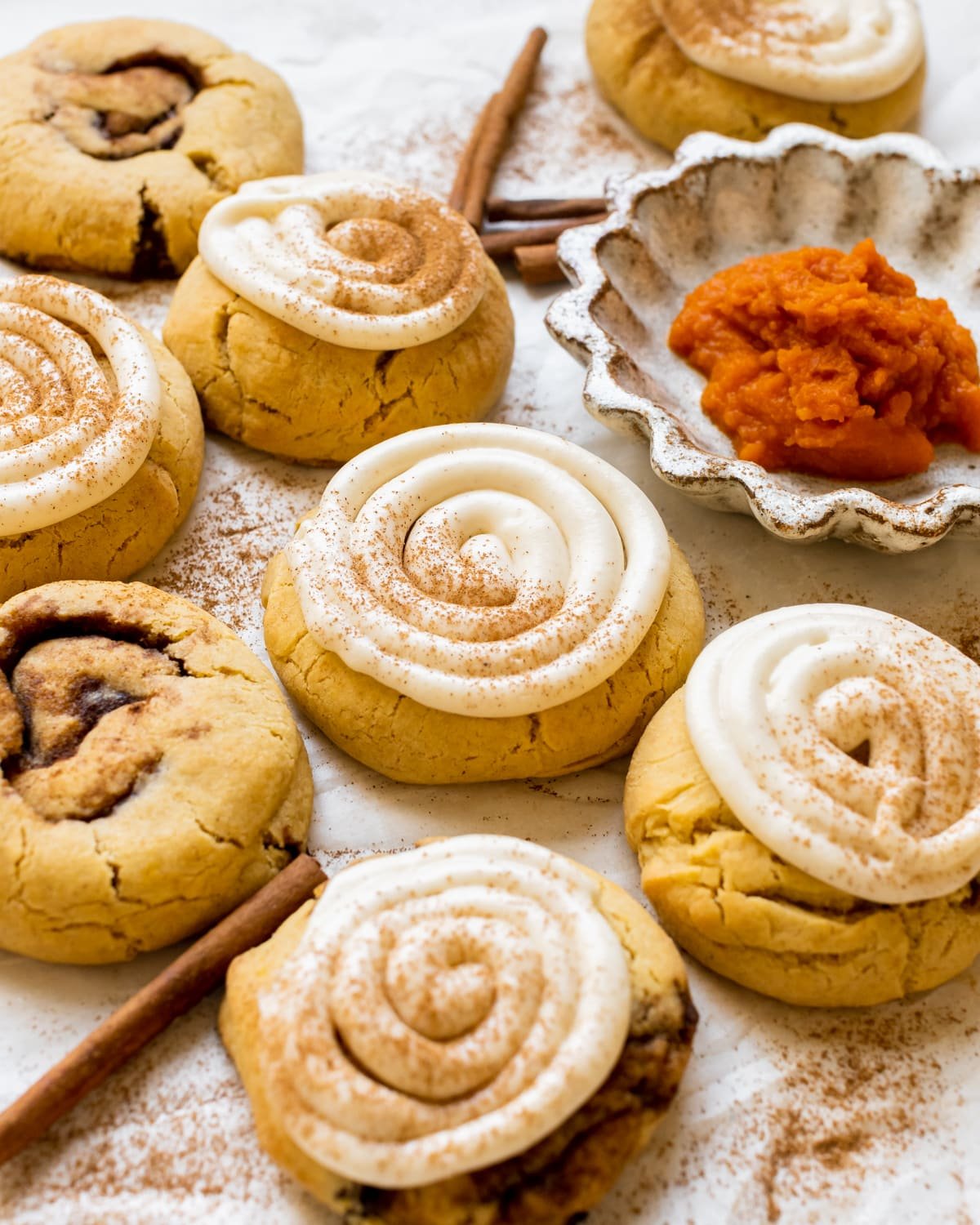 pumpkin cookies topped with cream cheese frosting and pumpkin pie spice.