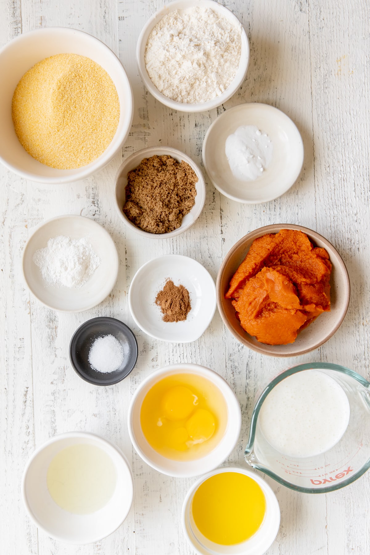 ingredients to make cornbread in small white bowls. 