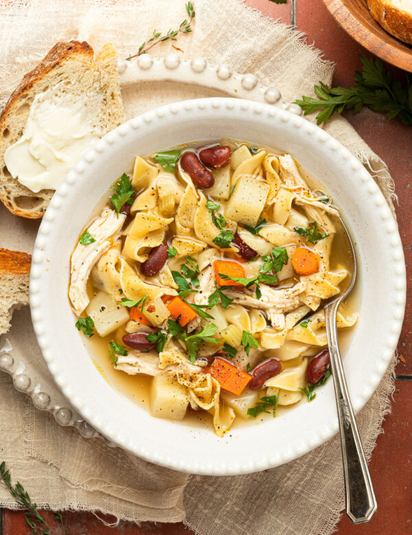 chicken noodle soup in bowl with spoon