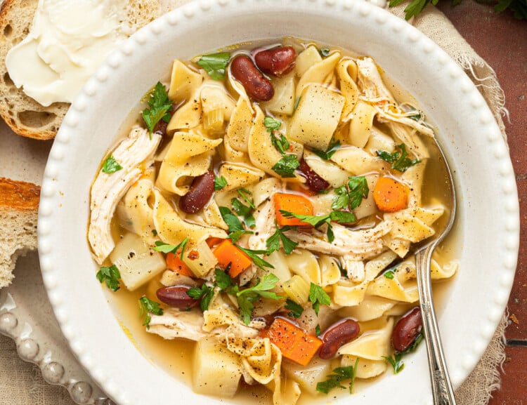 chicken noodle soup in bowl with spoon