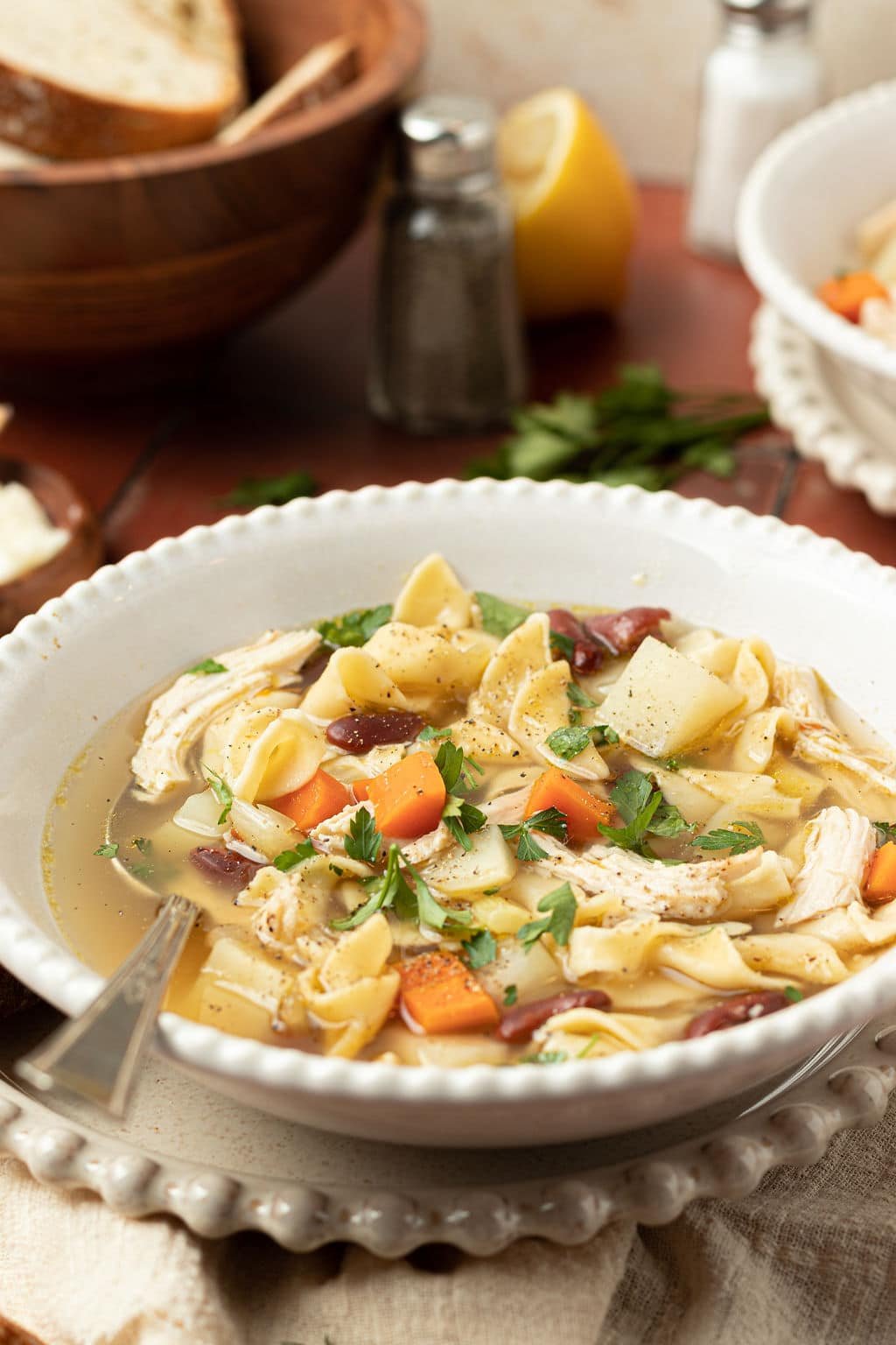 chicken noodle soup in a bowl with a spoon.