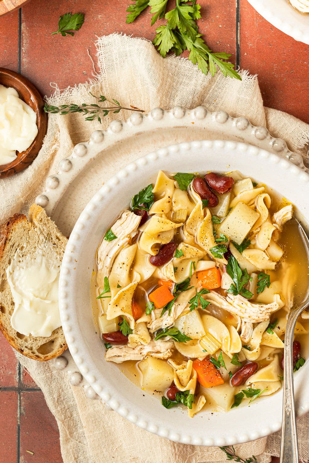 chicken noodle soup in bowl with spoon