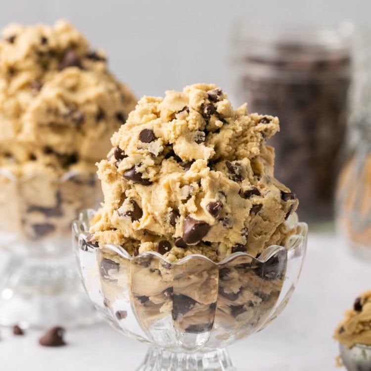 cookie dough with chocolate chips in a glass bowl.