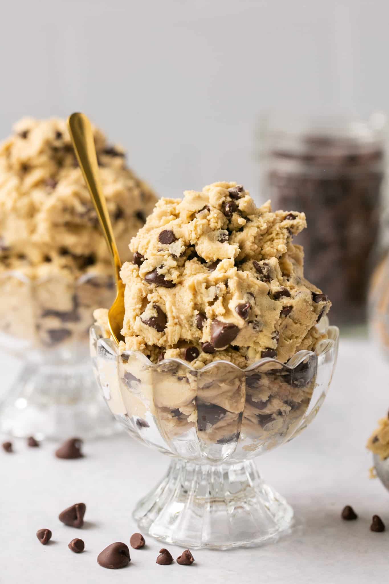 scooped cookie dough in a bowl with a golden spoon.