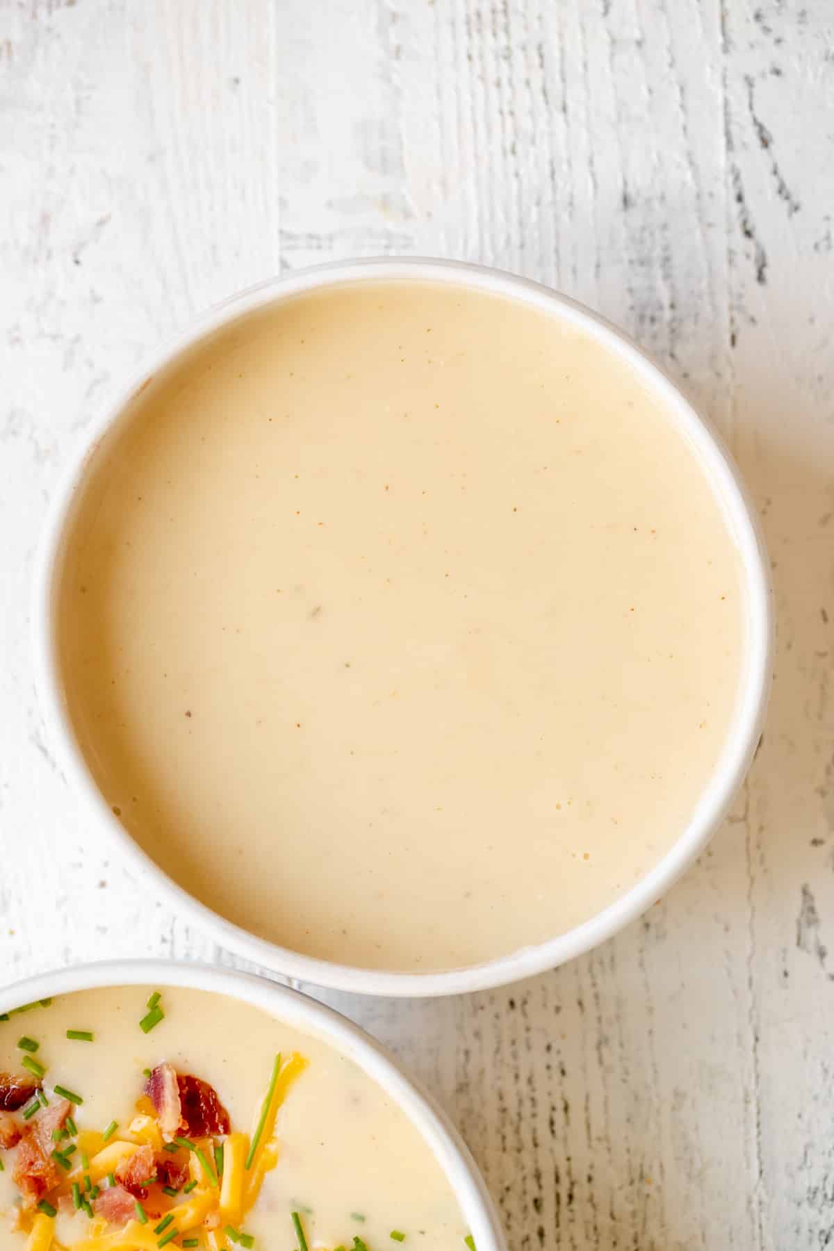 baked potato soup in a white bowl.