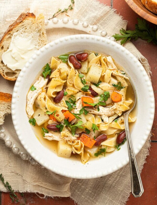 chicken noodle soup in bowl with spoon