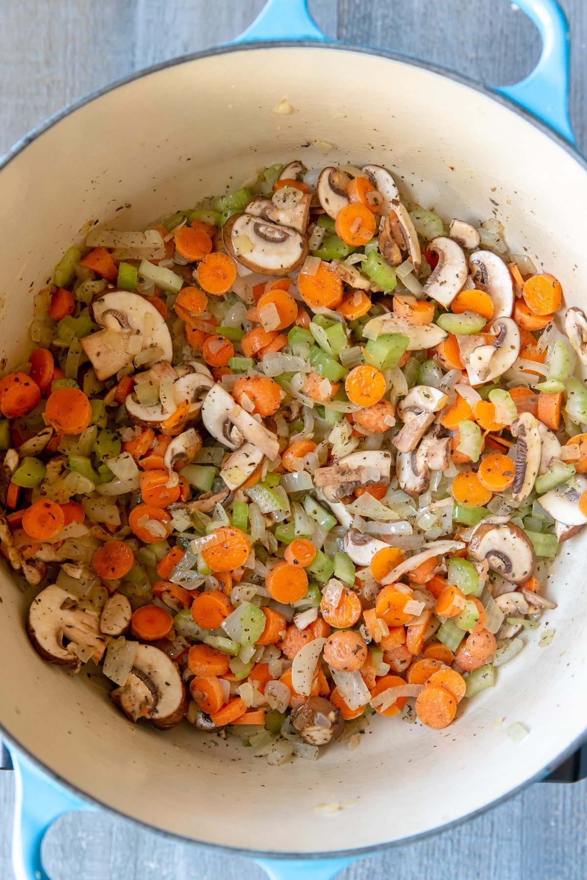 vegetables in a large blue dutch oven.