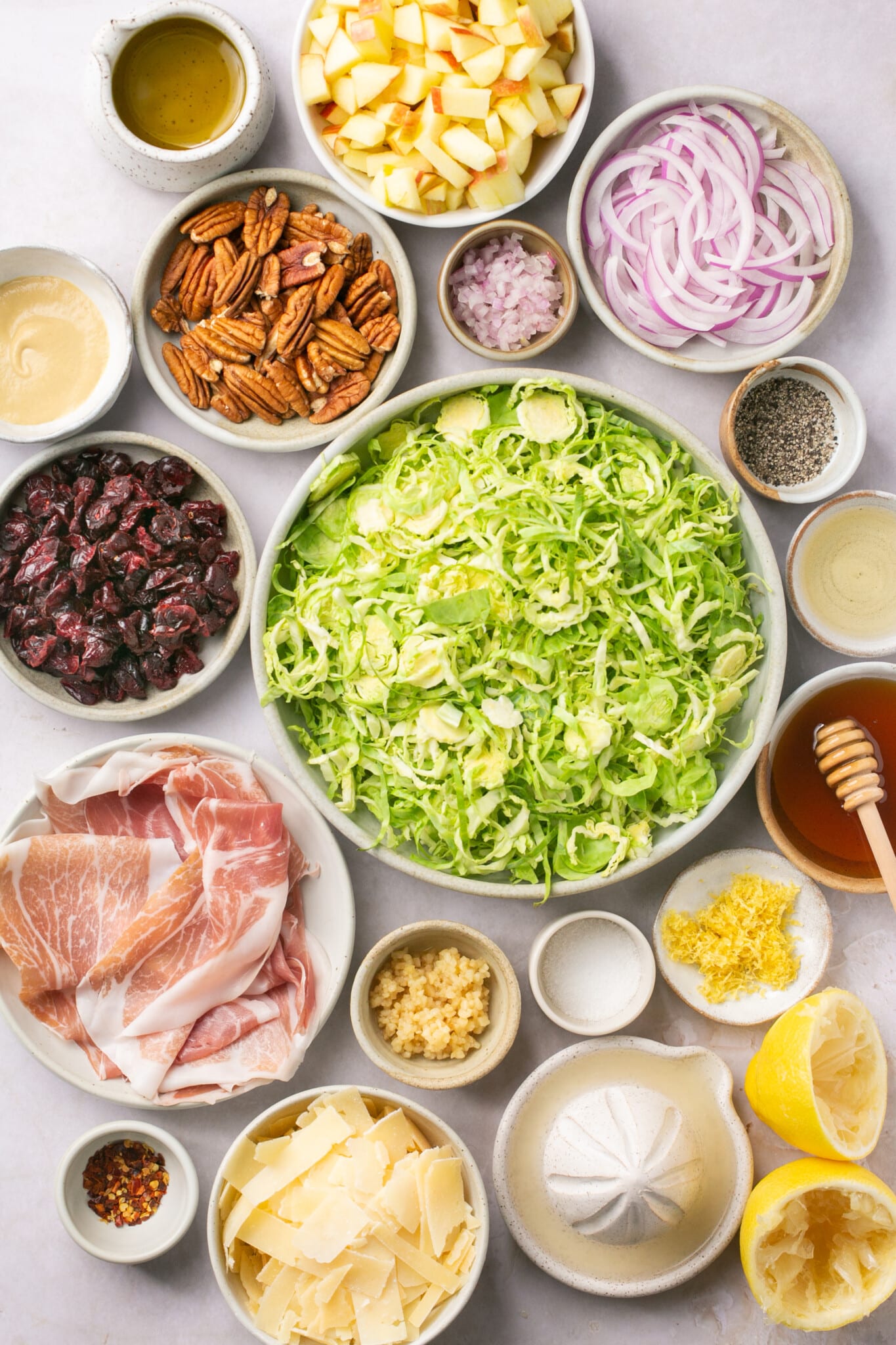 ingredients in small white bowls needed to make a salad. 