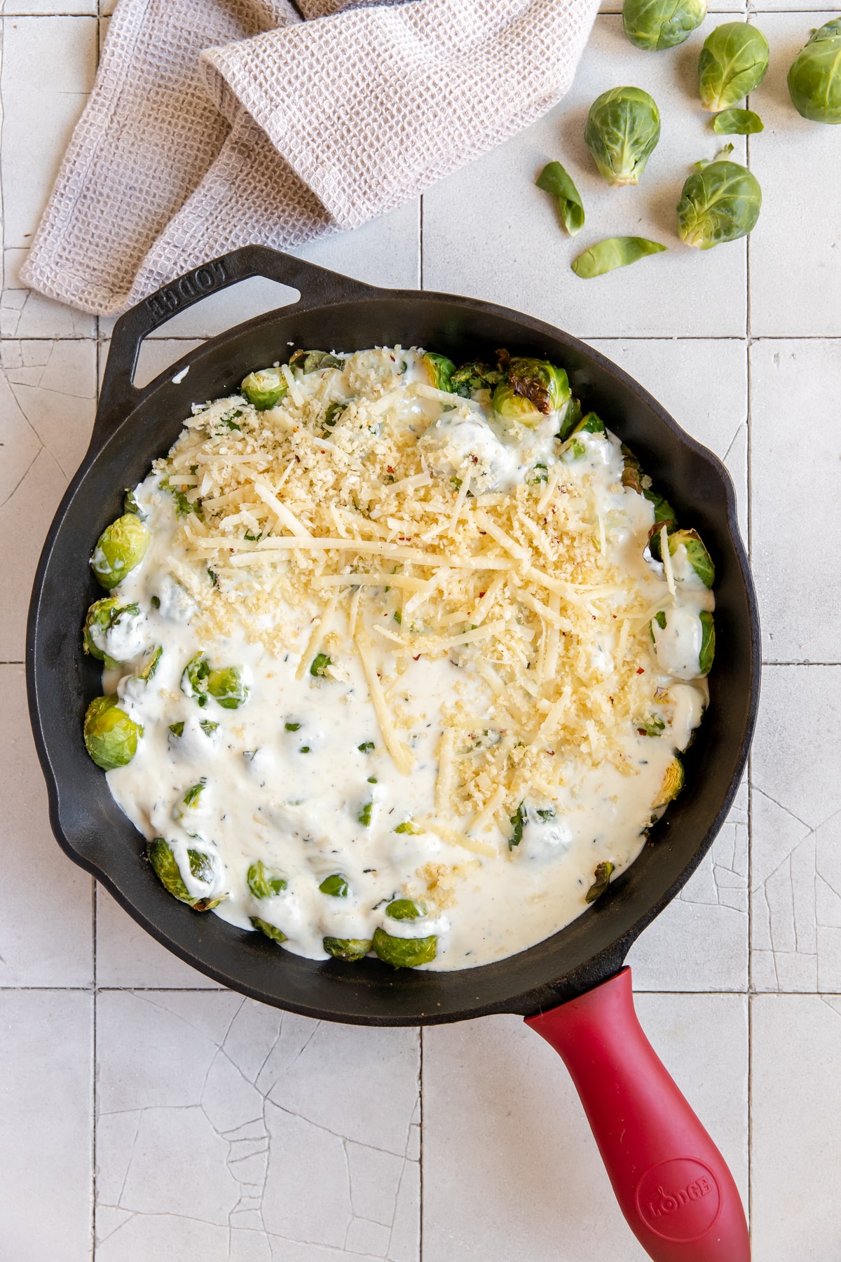 Brussels in a cast iron skillet with a creamy cheese sauce. 