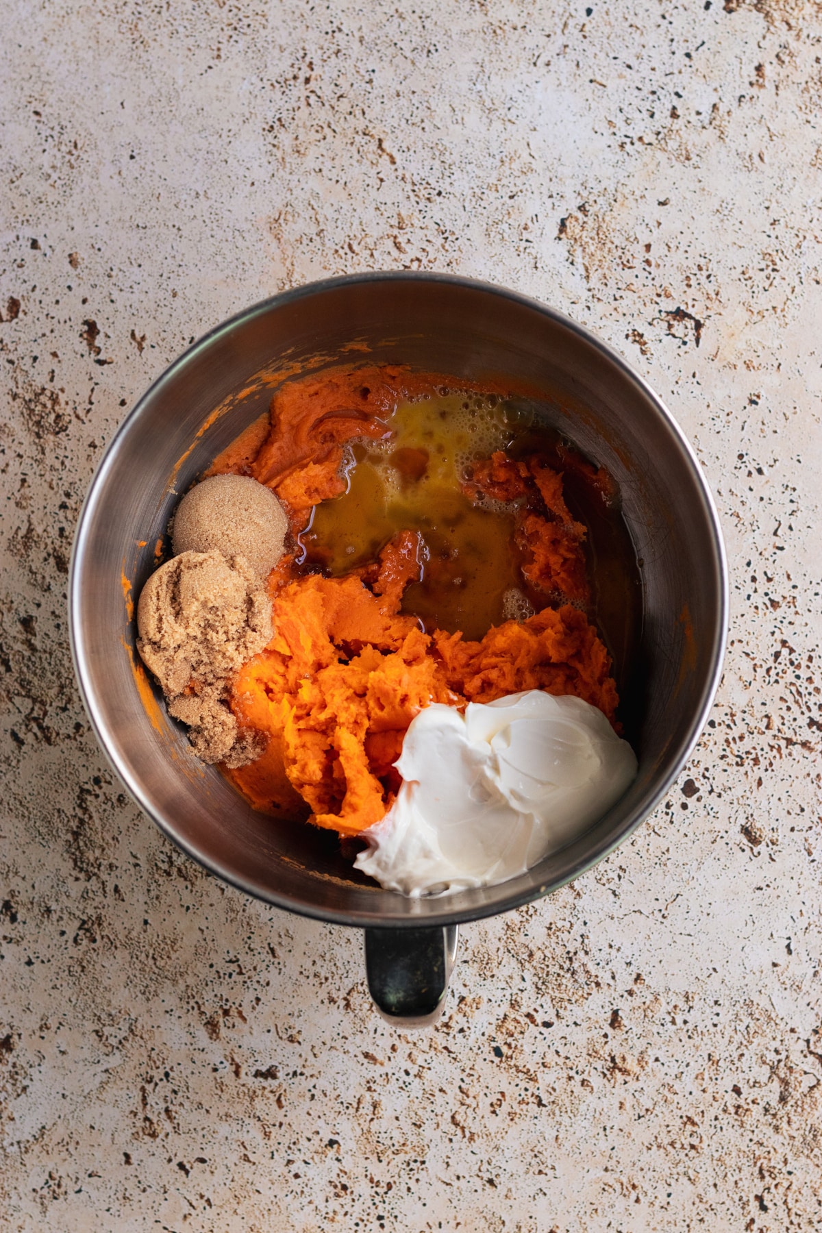 mashed sweet potatoes in a stainless steel bowl.