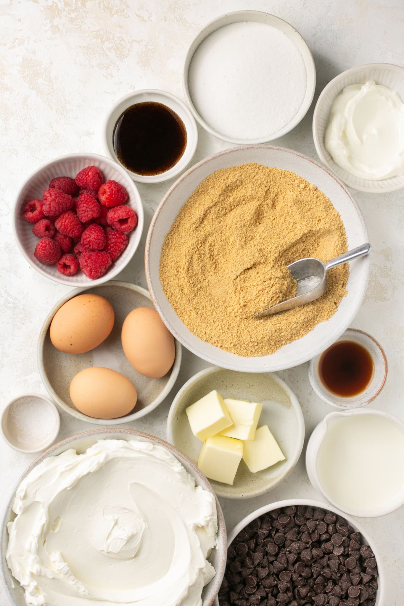 ingredients to make cheesecake bites in small glass bowls. 
