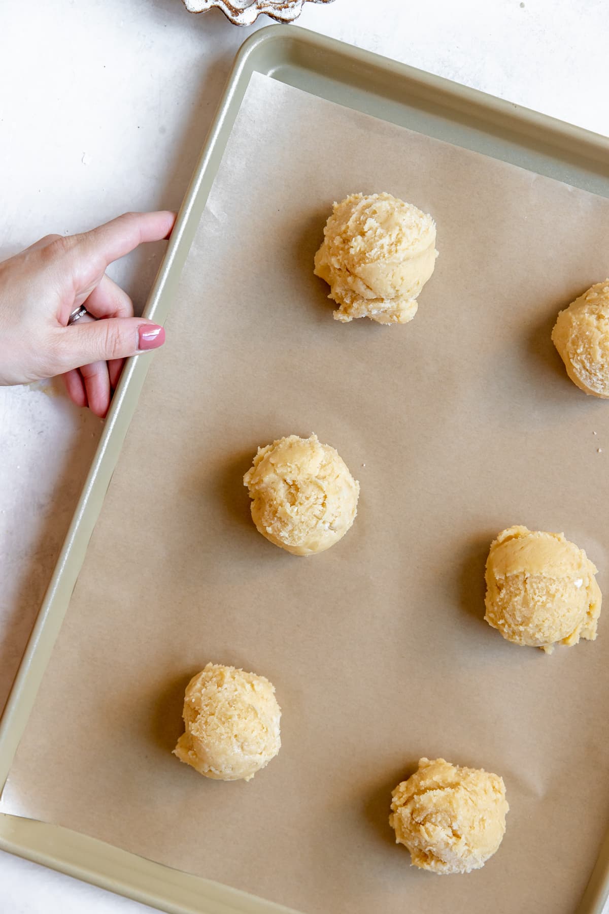 sugar cookies on a baking sheet lined with parchment paper. 