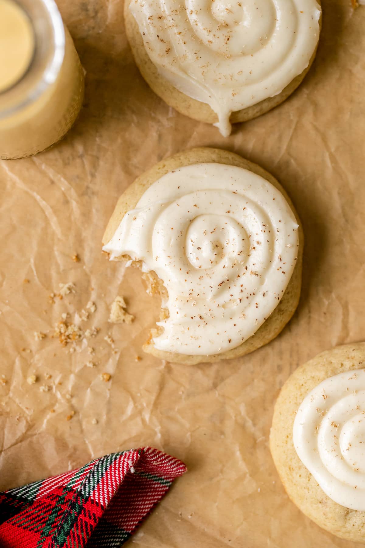 a cookie with frosting on top and a bite taken out of it. 