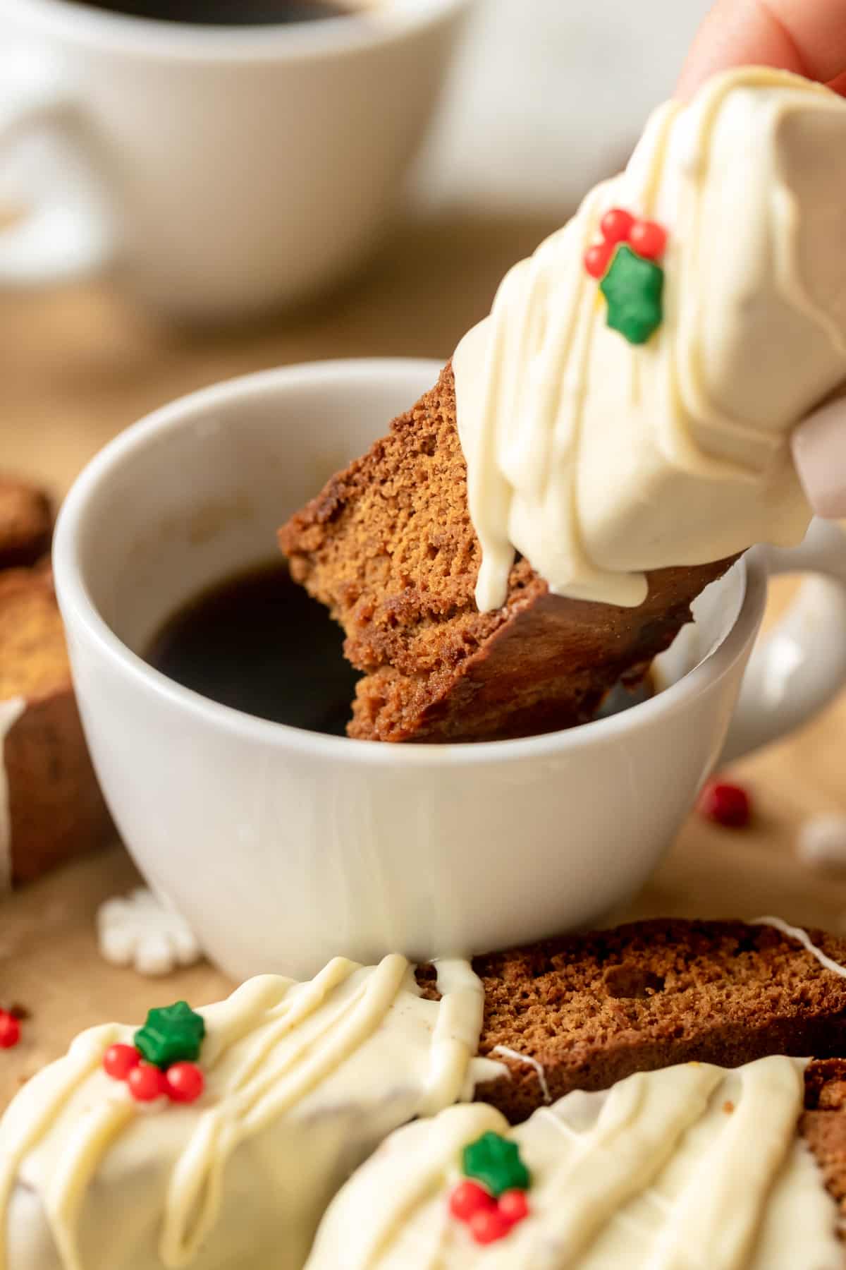 biscotti getting dunked into coffee. 