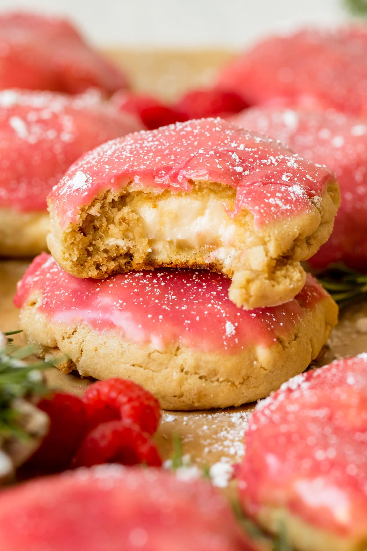 a bite taken into a raspberry cheesecake cookie.