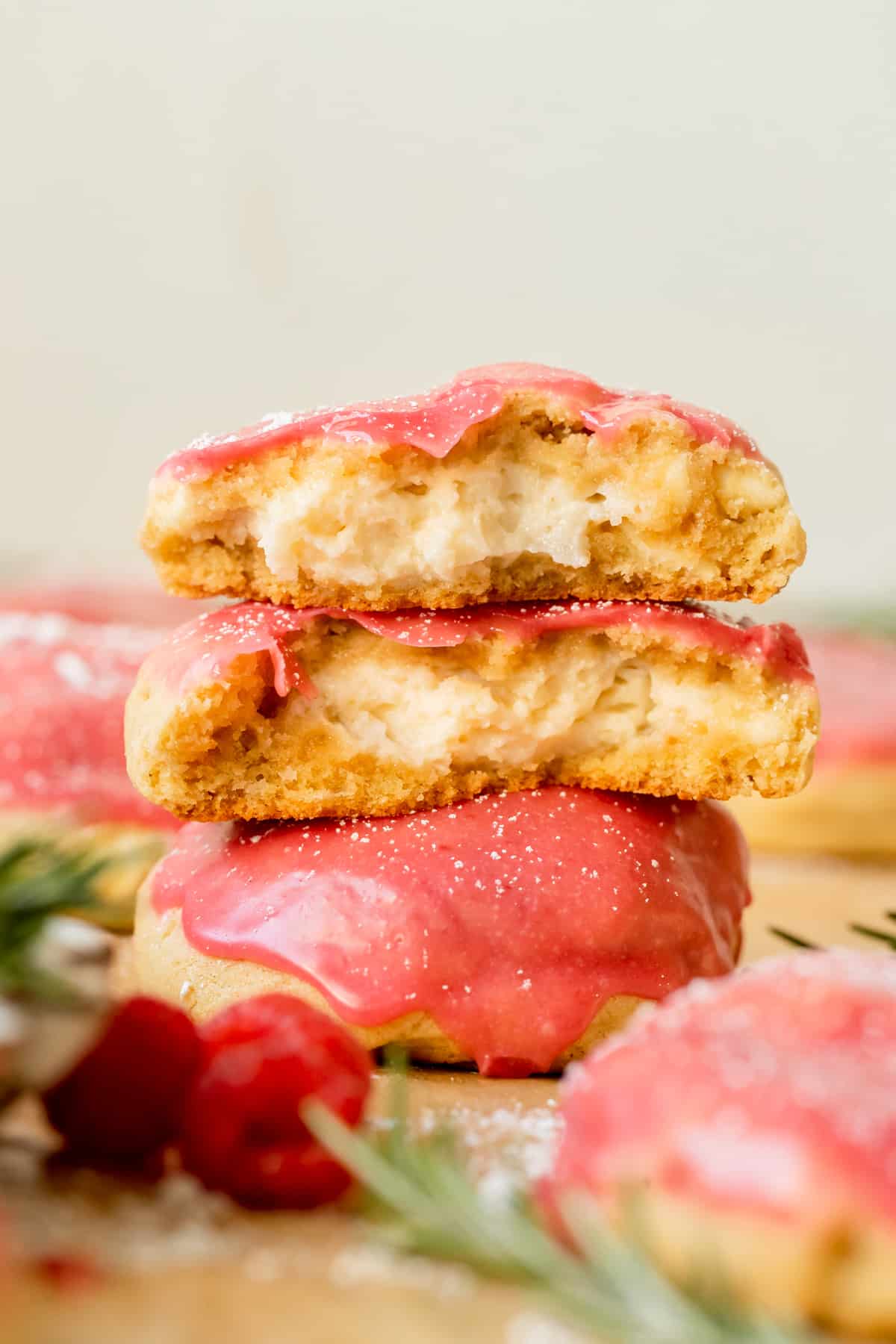 a raspberry cookie split in half stacked on top of each other.