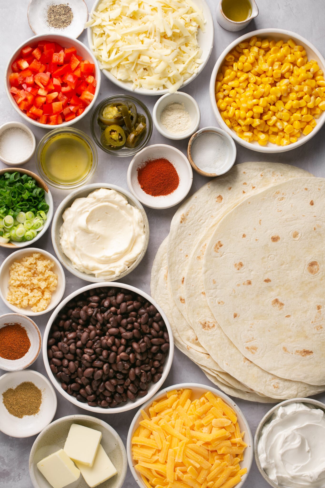 ingredients in small bowls needed to make quesadillas. 