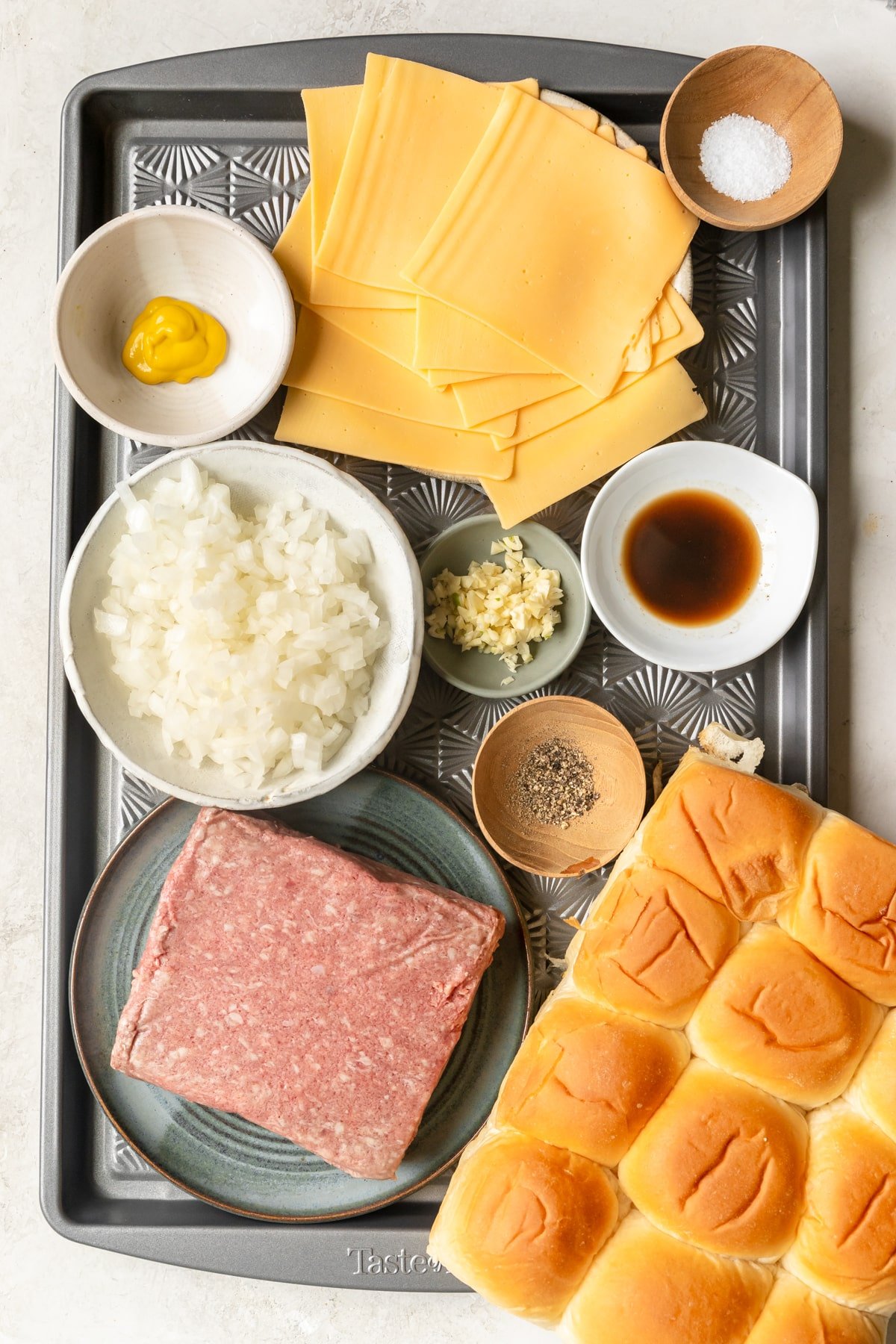 ingredients to make sliders on a sheet pan. 