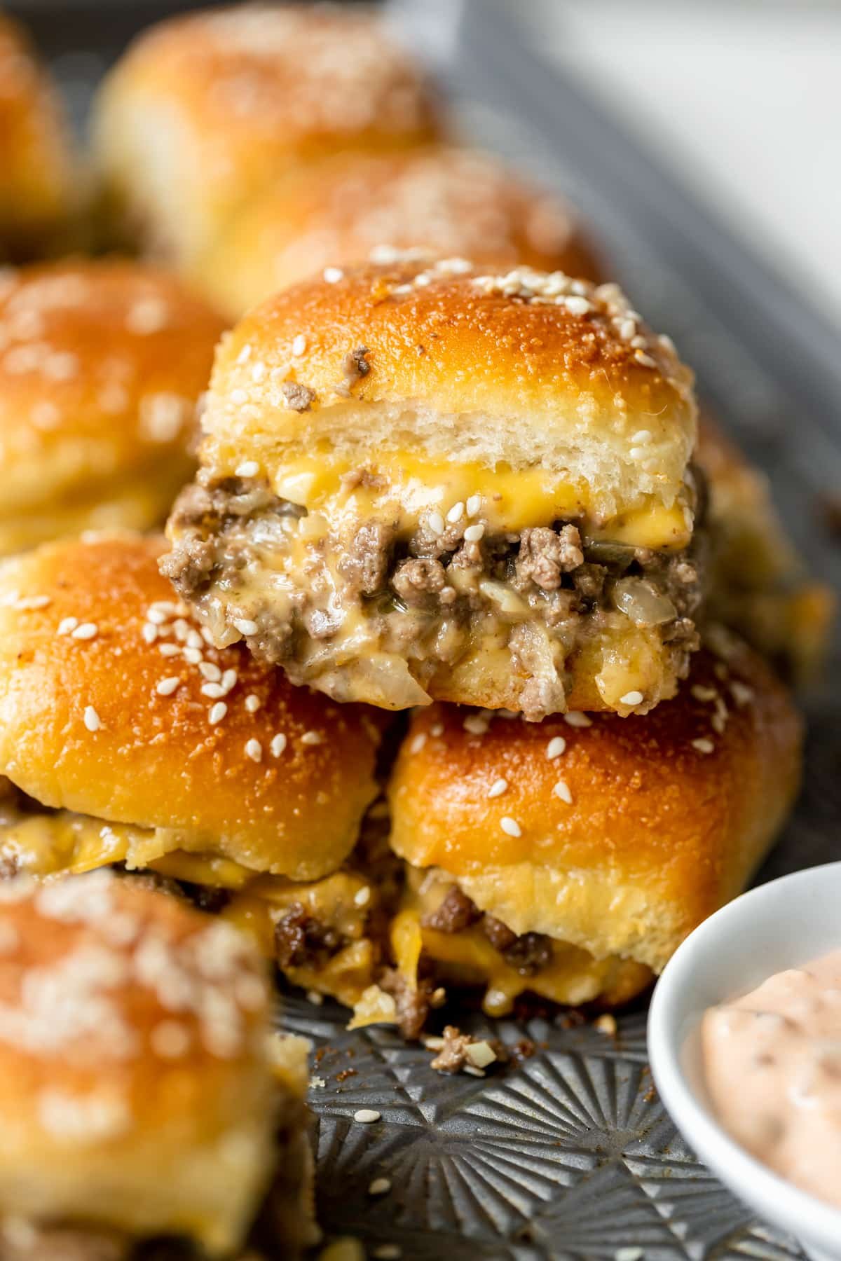 an up close image of a cheeseburger slider. 