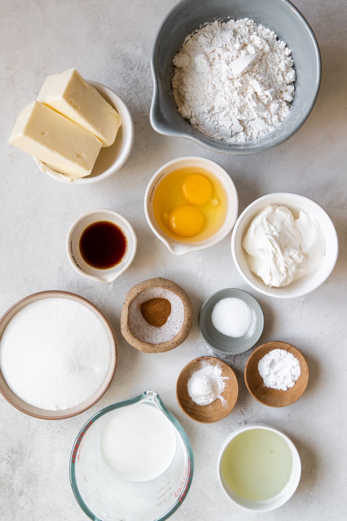 ingredients in glass bowls needed to make crumb cake. 