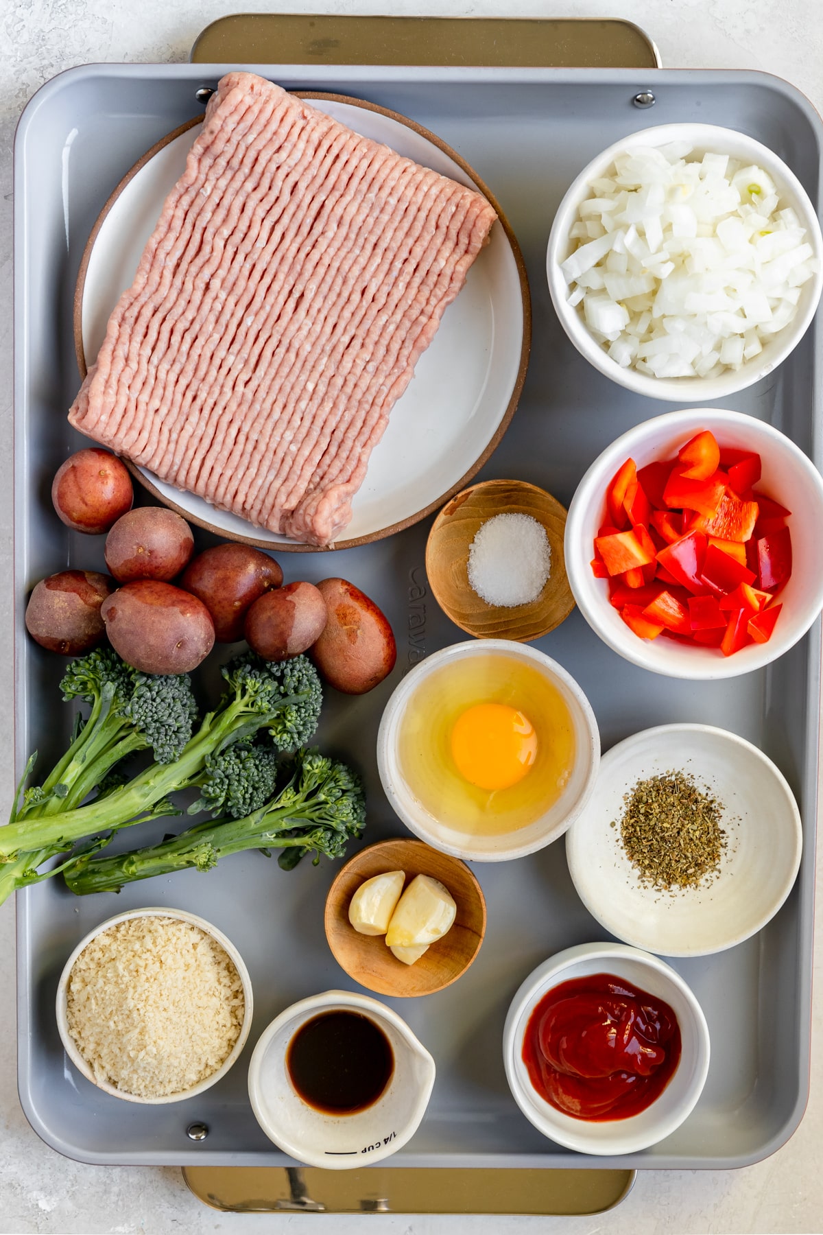 ingredients to make meatloaf on a sheet pan.