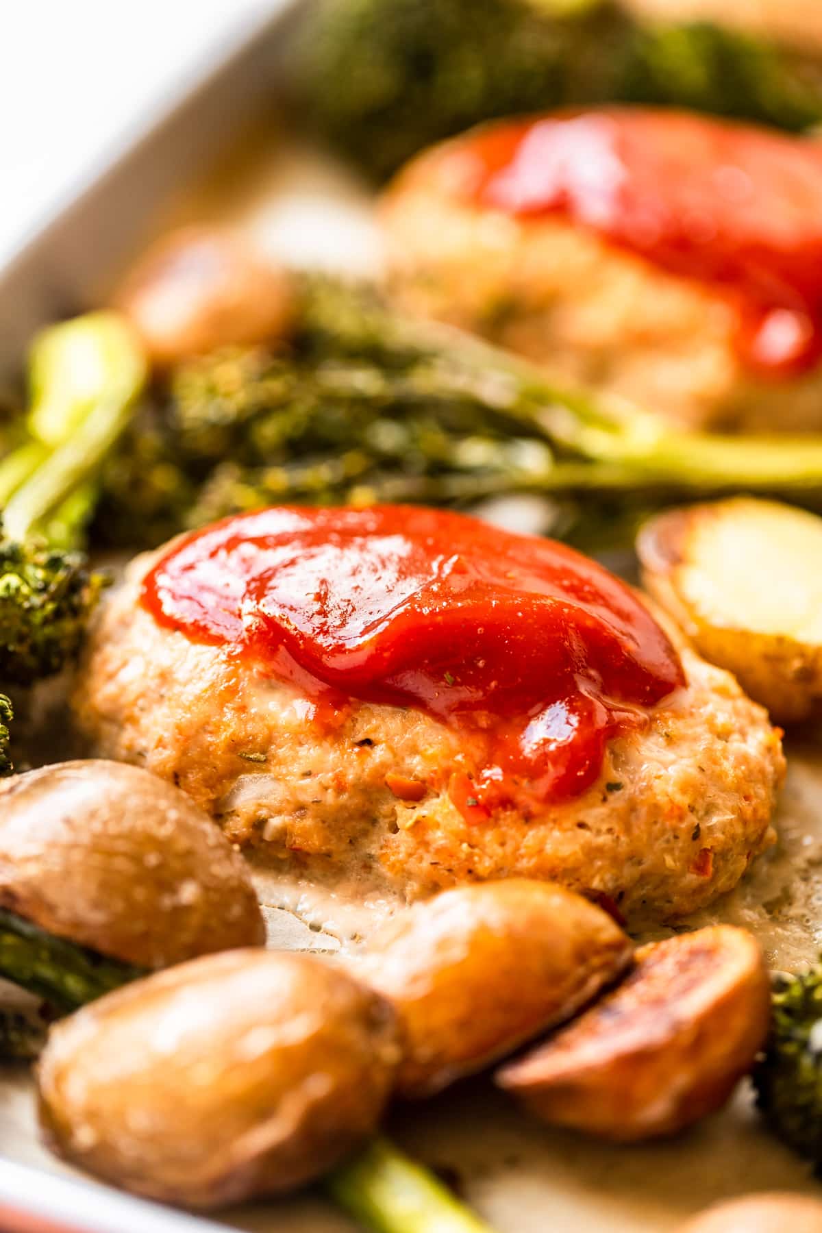 an up close image of a meatloaf topped with a ketchup glaze. 