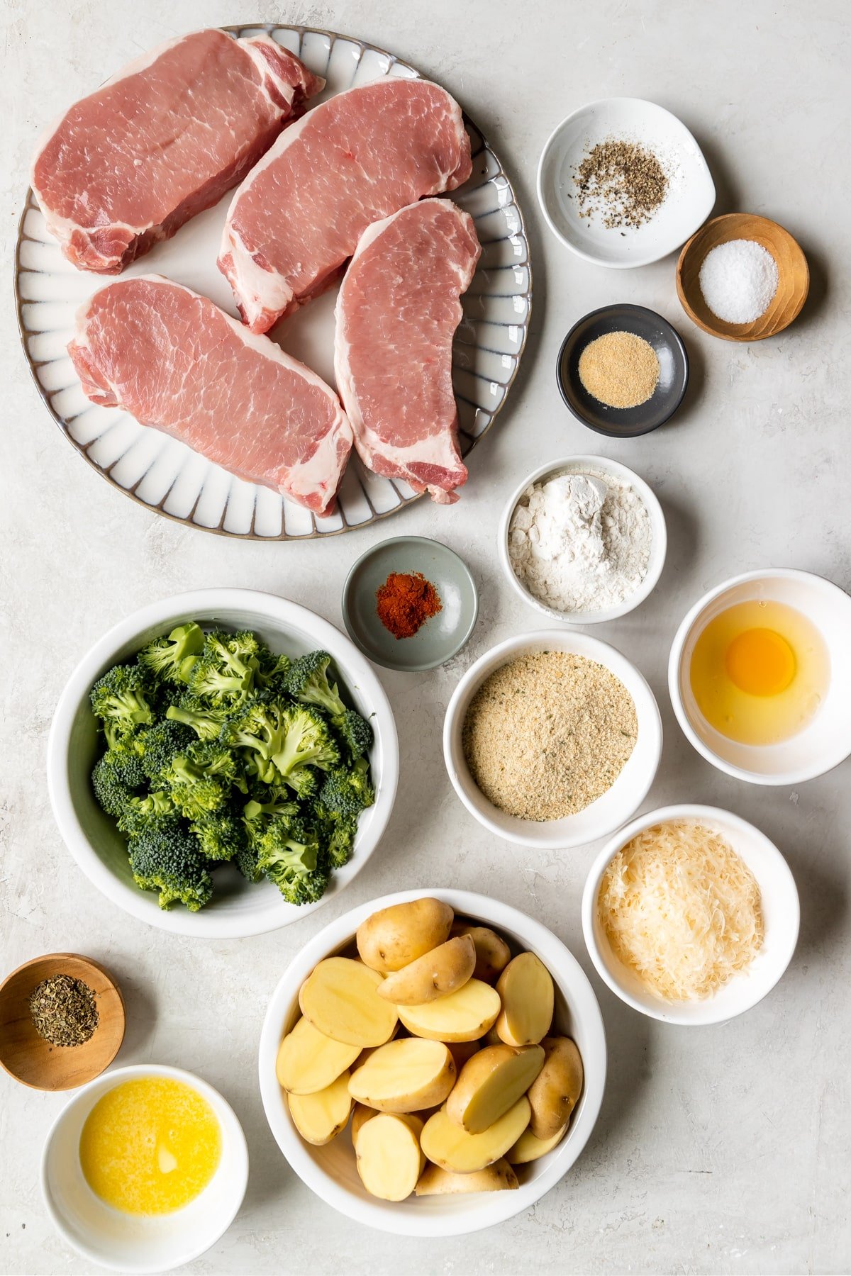 ingredients to make a sheet pan dinner in small white bowls. 