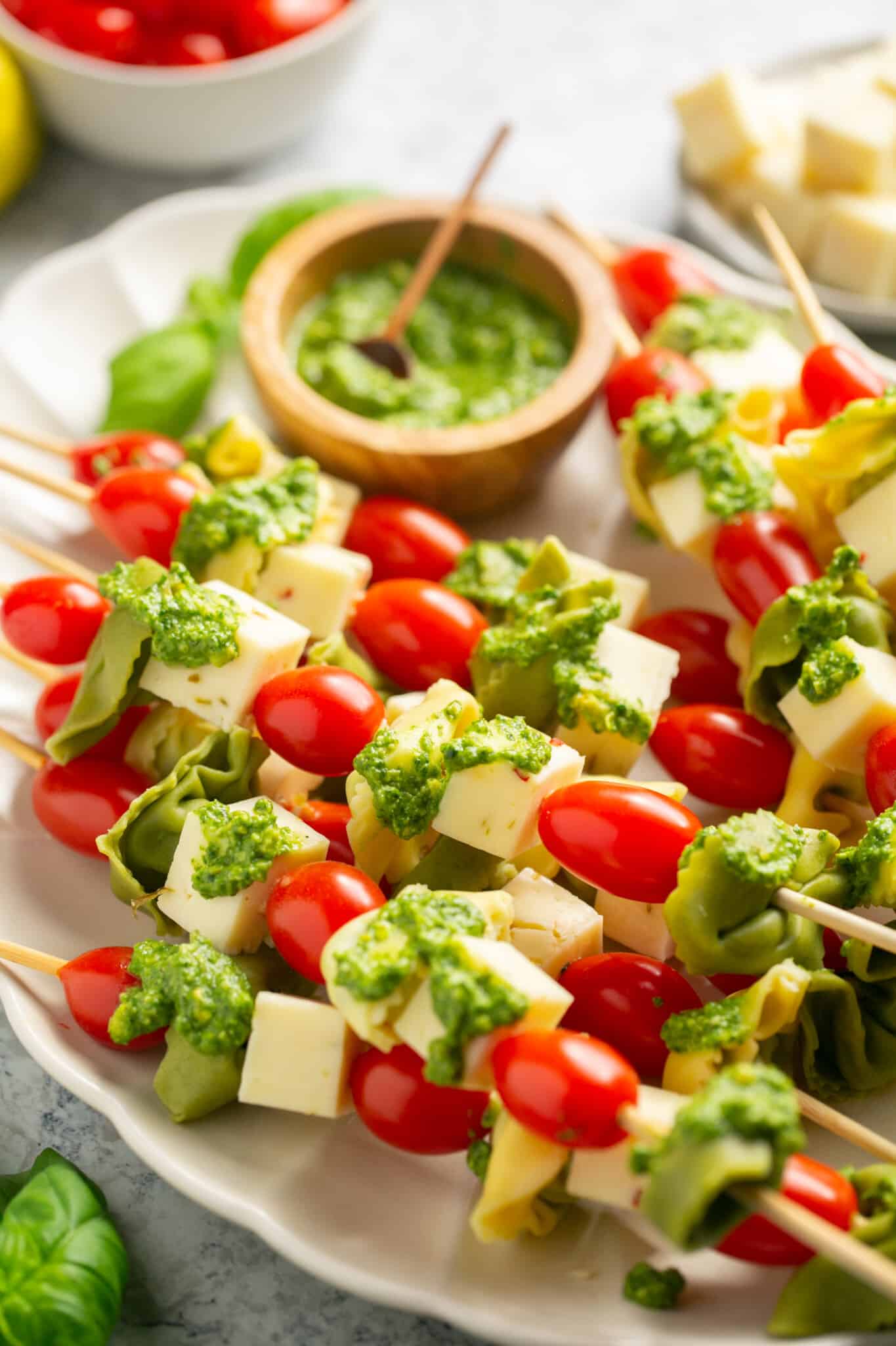 tortellini on skewers with pesto on them. 