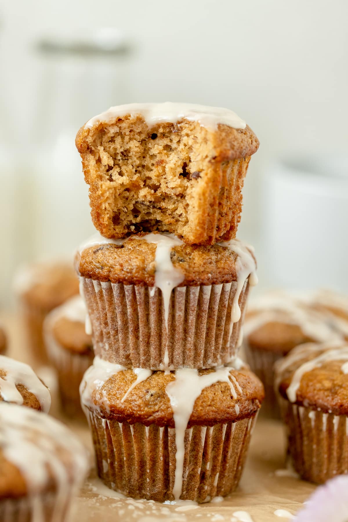 muffins stacked on top of each other with a vanilla glaze on top. 