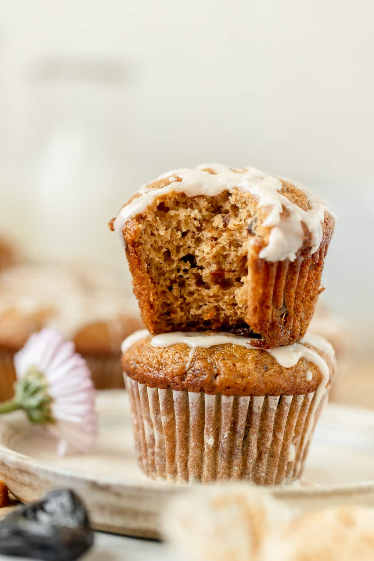 muffins stacked on top of each other with a vanilla glaze on top. 