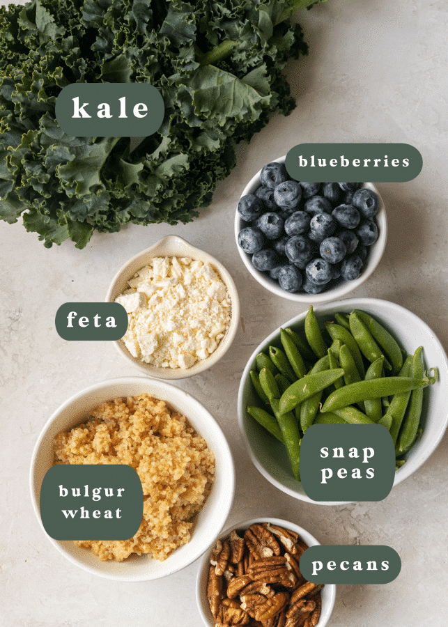 ingredients needed to make salad in small white bowls. 